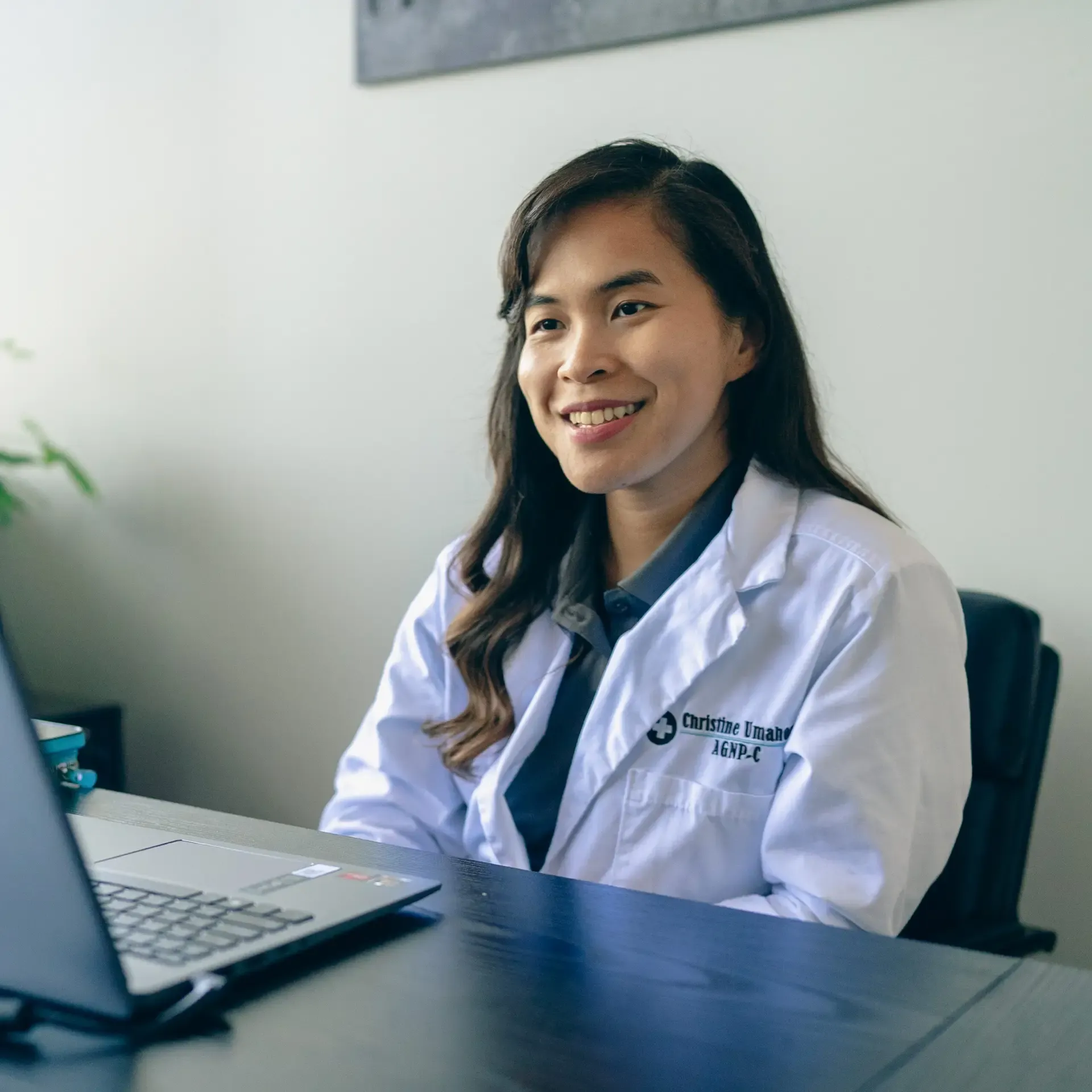 An Xcel nurse practitioner at her desk in the clinic