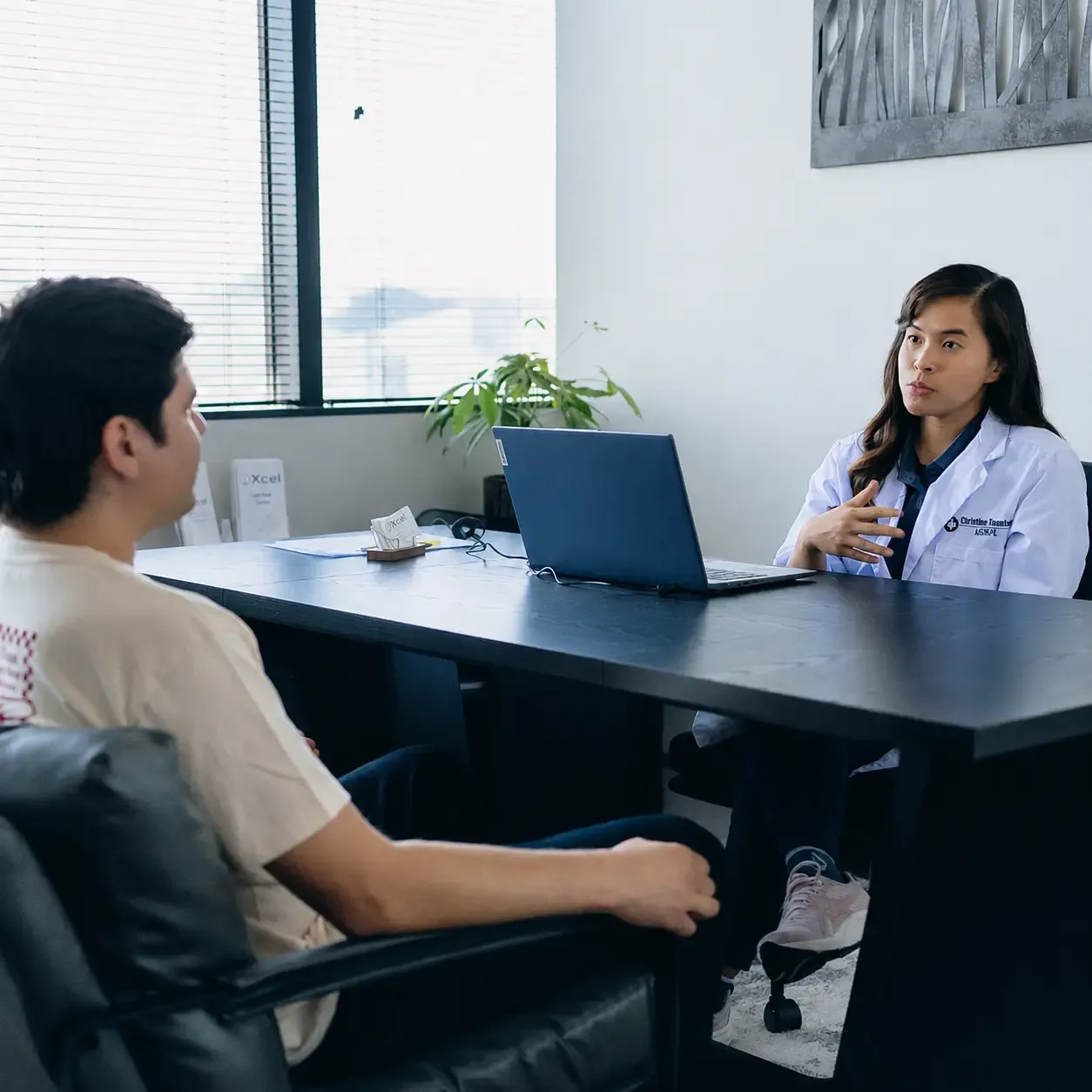 An Xcel provider meeting with a patient
